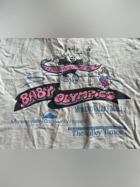 🪄RARE VTG 90’s Neon Baby Olympics white t shirt Moreno Valley Inland Empire